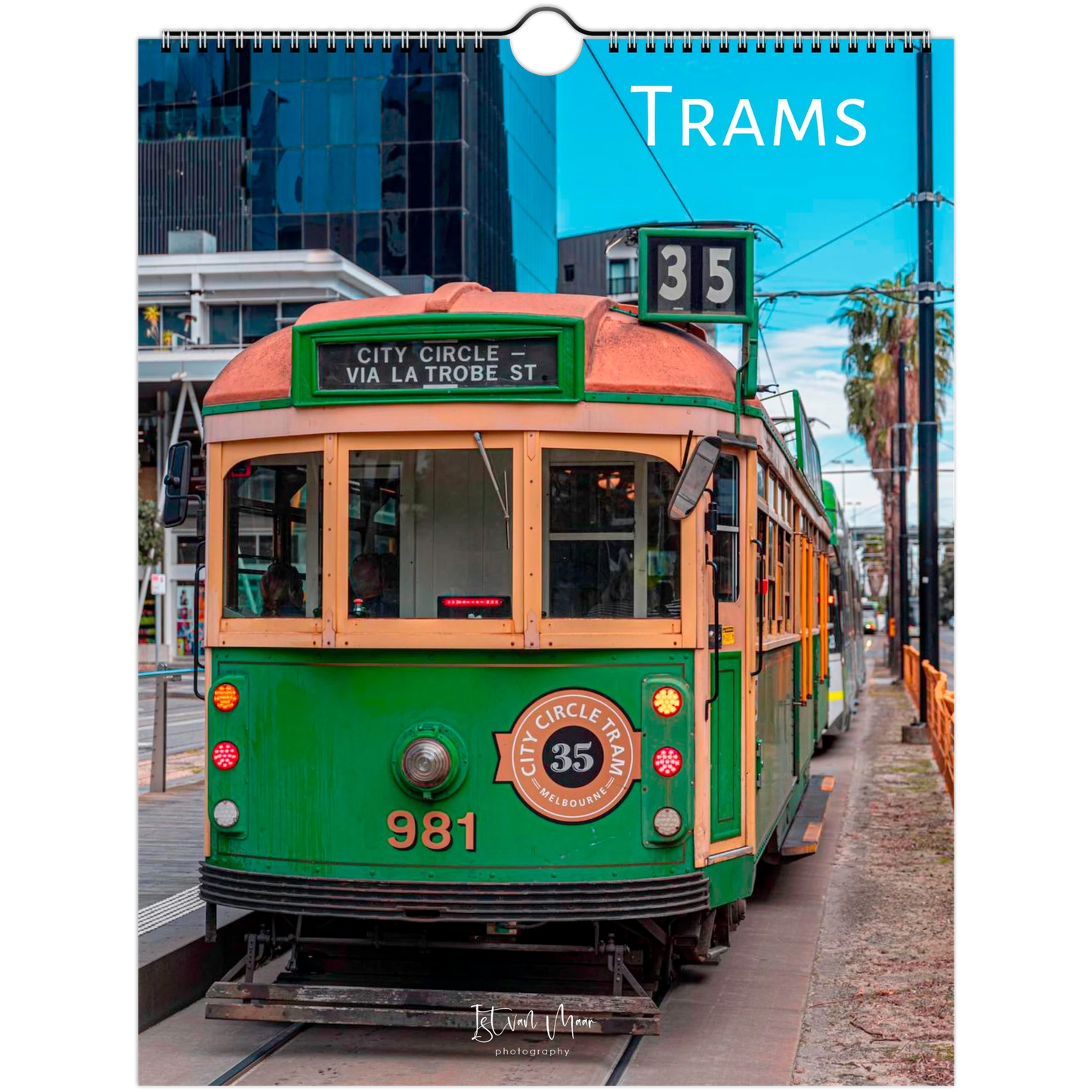 A spiral-bound wall calendar page featuring a vintage green and cream tram on a city street, with the word 'TRAMS' in white at the top right and a small 'K' mark near the bottom. Product of Istvan Maar Photography, available in A4, A3, LT and LG sizes.
