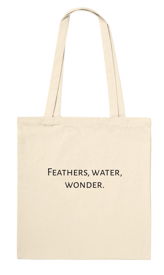 Natural canvas tote bag with personalised 'Feathers, water, wonder.' text on the back