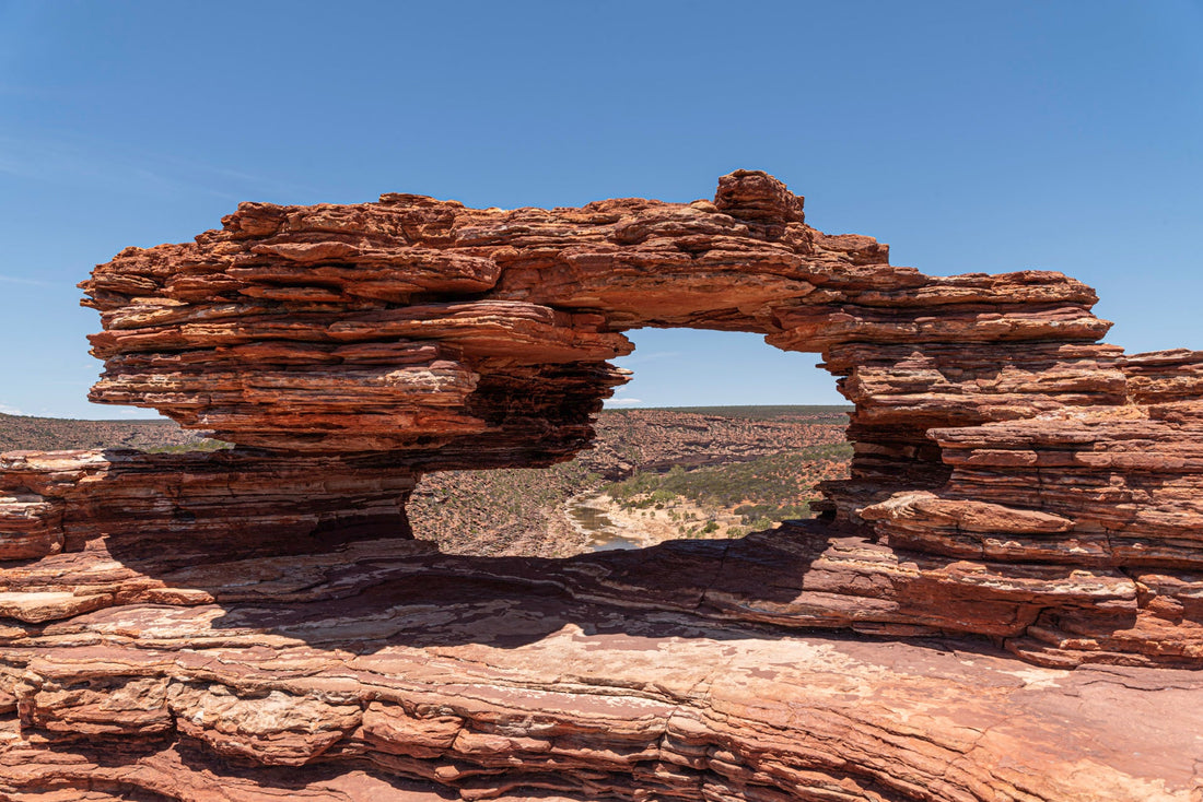 Sandstone rock arch framing a river gorge landscape, resembling Nature's Window in Kalbarri National Park, Western Australia