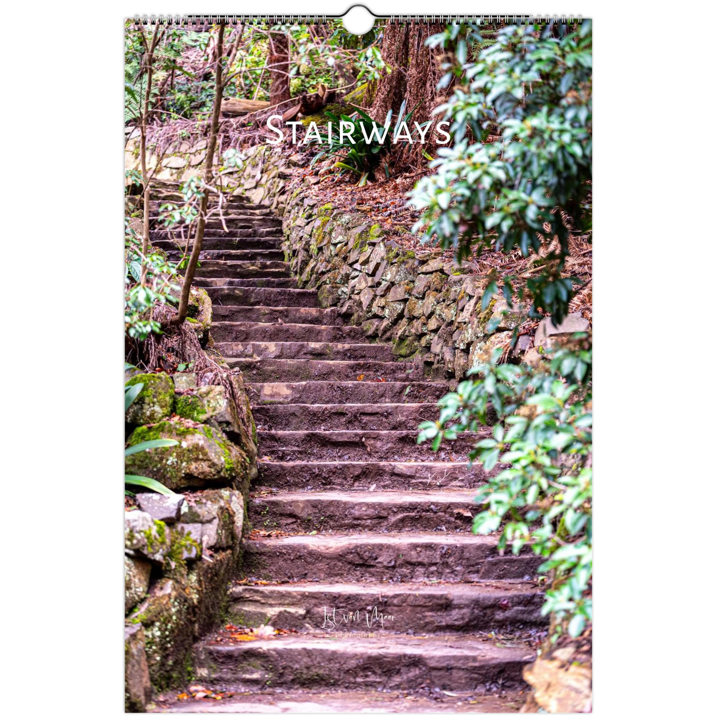 A spiral-bound wall calendar or print featuring a photograph of stone stairways winding through a lush green forest, with the word 'STAIRWAYS' printed across the upper portion.
