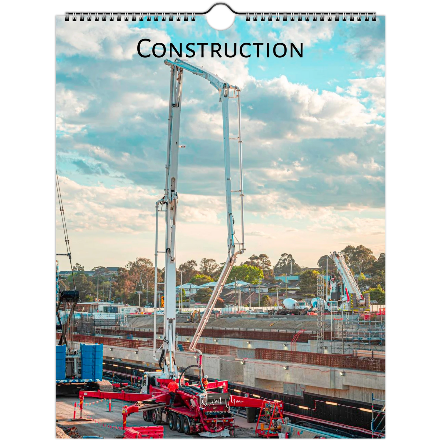 A spiral-bound wall calendar or print featuring a construction site scene with a tall concrete pump under a blue sky with clouds, with the word "CONSTRUCTION" printed at the top. Available in A4, A3, LT, LG sizes.