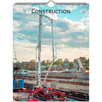 A spiral-bound wall calendar or print featuring a construction site scene with a tall concrete pump under a blue sky with clouds, with the word "CONSTRUCTION" printed at the top. Available in A4, A3, LT, LG sizes.