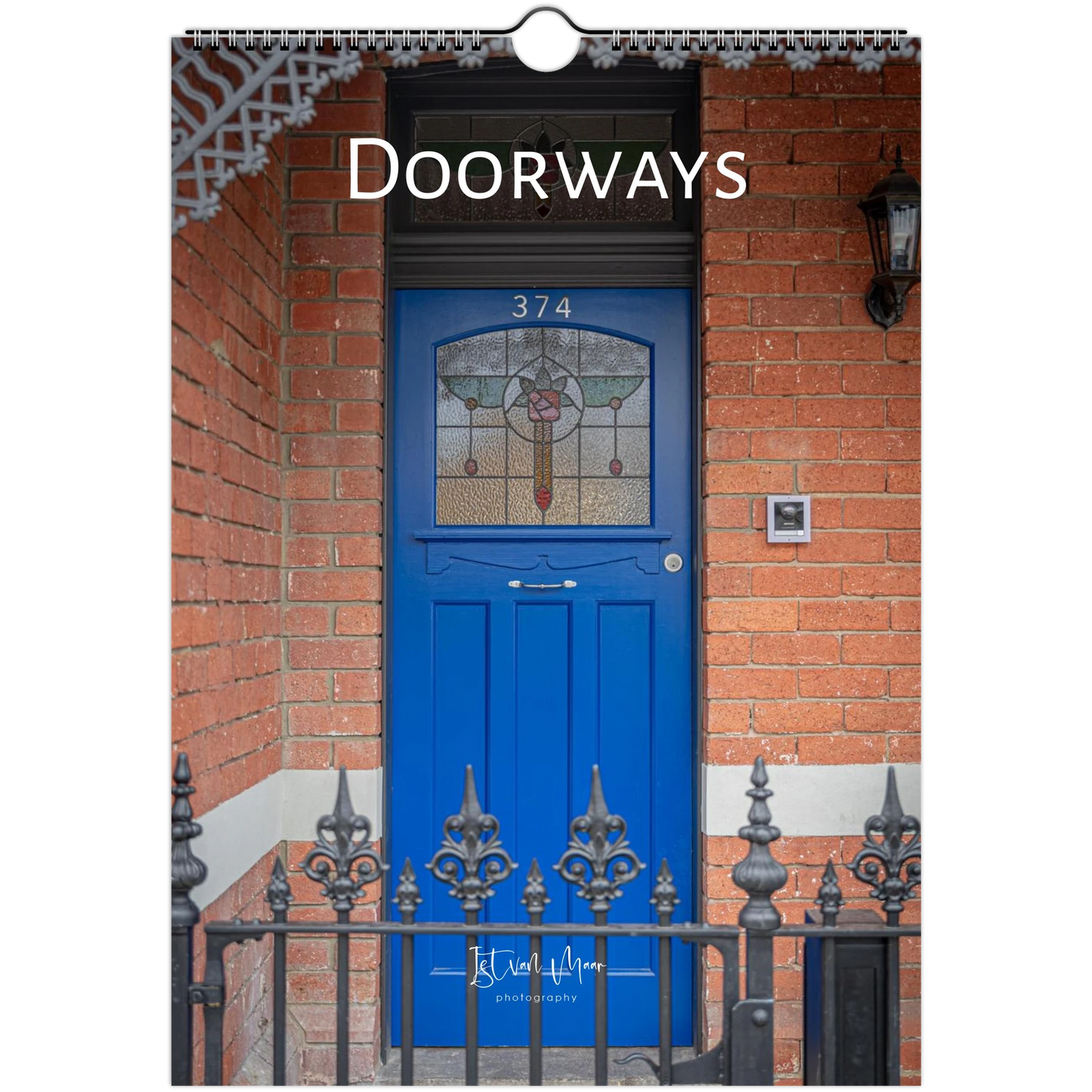 A vertical photographic print or poster showing a bright blue front door set in a red brick doorway, with the word 'DOORWAYS' across the top and a small hanging loop at the top center.