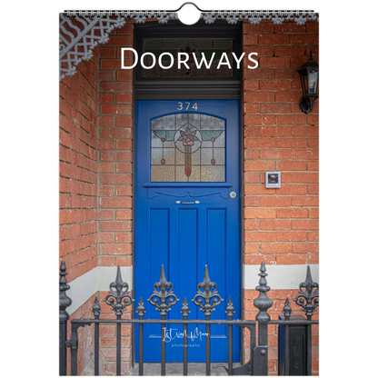 A vertical photographic print or poster showing a bright blue front door set in a red brick doorway, with the word 'DOORWAYS' across the top and a small hanging loop at the top center.