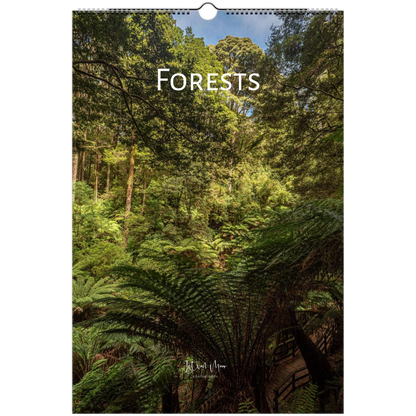 A vertical wall calendar or print featuring a forest scene with ferns and trees, with the word 'FORESTS' in large white text across the upper middle. The product is shown against a white background with a hanging hole at the top.