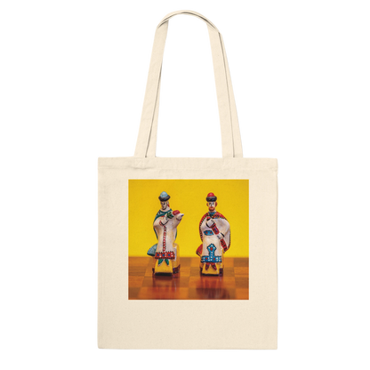 A natural canvas tote bag with a square graphic print on the front depicting two vintage toy soldiers on a yellow and brown background. Ships worldwide by Istvan Maar Photography.