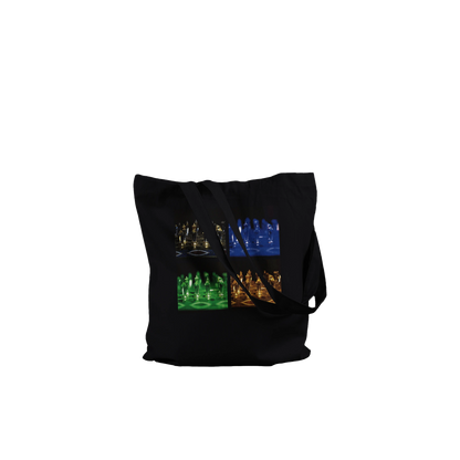 A black canvas tote bag with a long shoulder strap, featuring a graphic print of four mini-golf courses in different colors (blue, green, orange, and yellow) on the front, set against a plain white background.