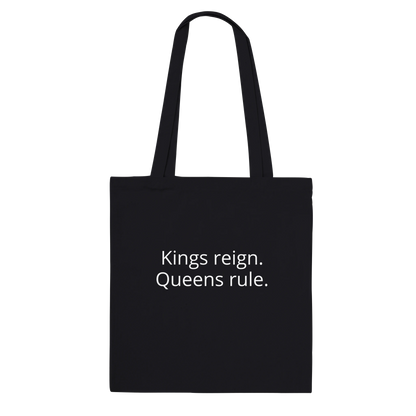 Back of Bronze Chess Set Tote Bag Black Classic – Kings reign. Queens rule. printed in white font