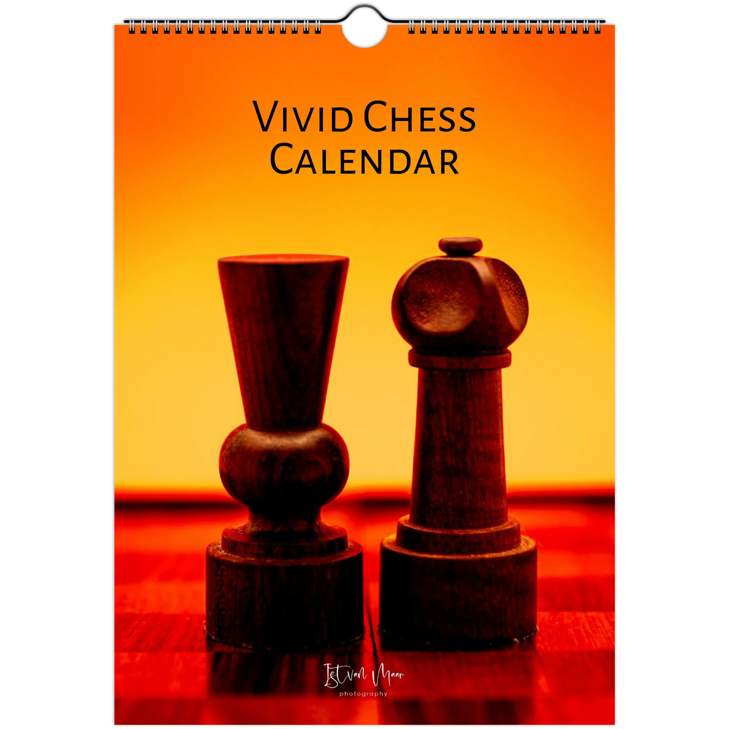 A hanging wall calendar titled 'VIVID CHESS CALENDAR' with a spiral binding at the top. The cover features a warm orange-to-yellow gradient background with two dark wooden chess pieces on a red surface.