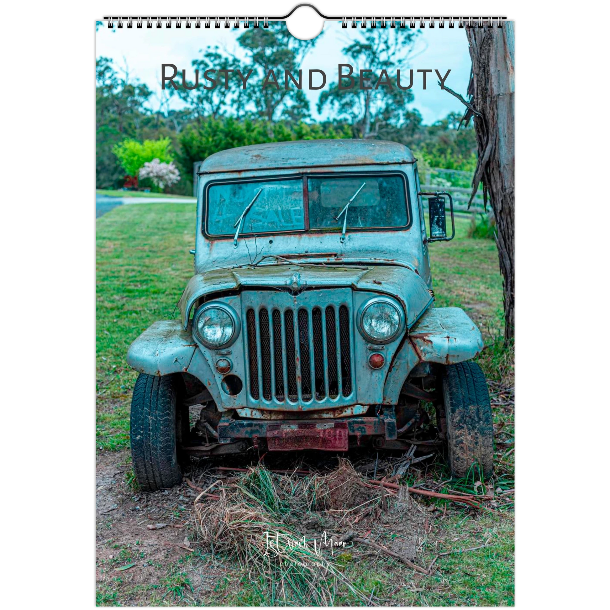 A wall-hung calendar or print featuring a vintage distressed blue-green truck outdoors on grass and dirt, with the words 'Rusty and Beauty' across the top. Available in A4, A3, Letter and Ledger US sizes.
