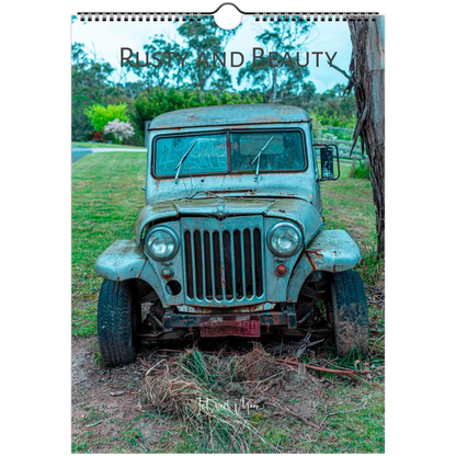 A wall-hung calendar or print featuring a vintage distressed blue-green truck outdoors on grass and dirt, with the words 'Rusty and Beauty' across the top. Available in A4, A3, Letter and Ledger US sizes.