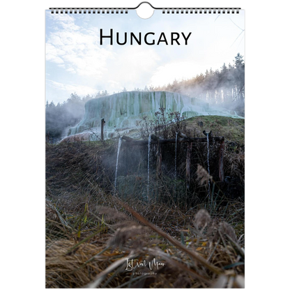 A hanging wall calendar or poster featuring a scenic photograph of a geothermal landscape in Hungary, with the word "HUNGARY" printed at the top and a spiral binding at the top edge. The scene shows steam, trees, and waterfalls in muted blue-green, brown, and gray tones.