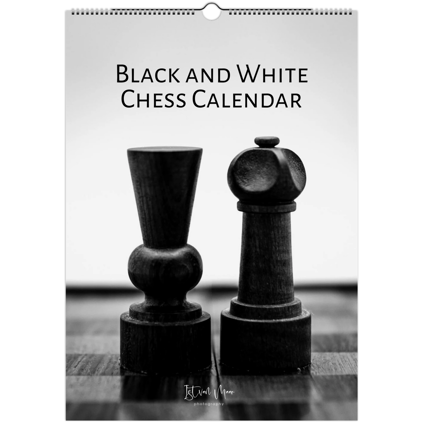 Black and white chess calendar with two chess pieces on a wooden surface