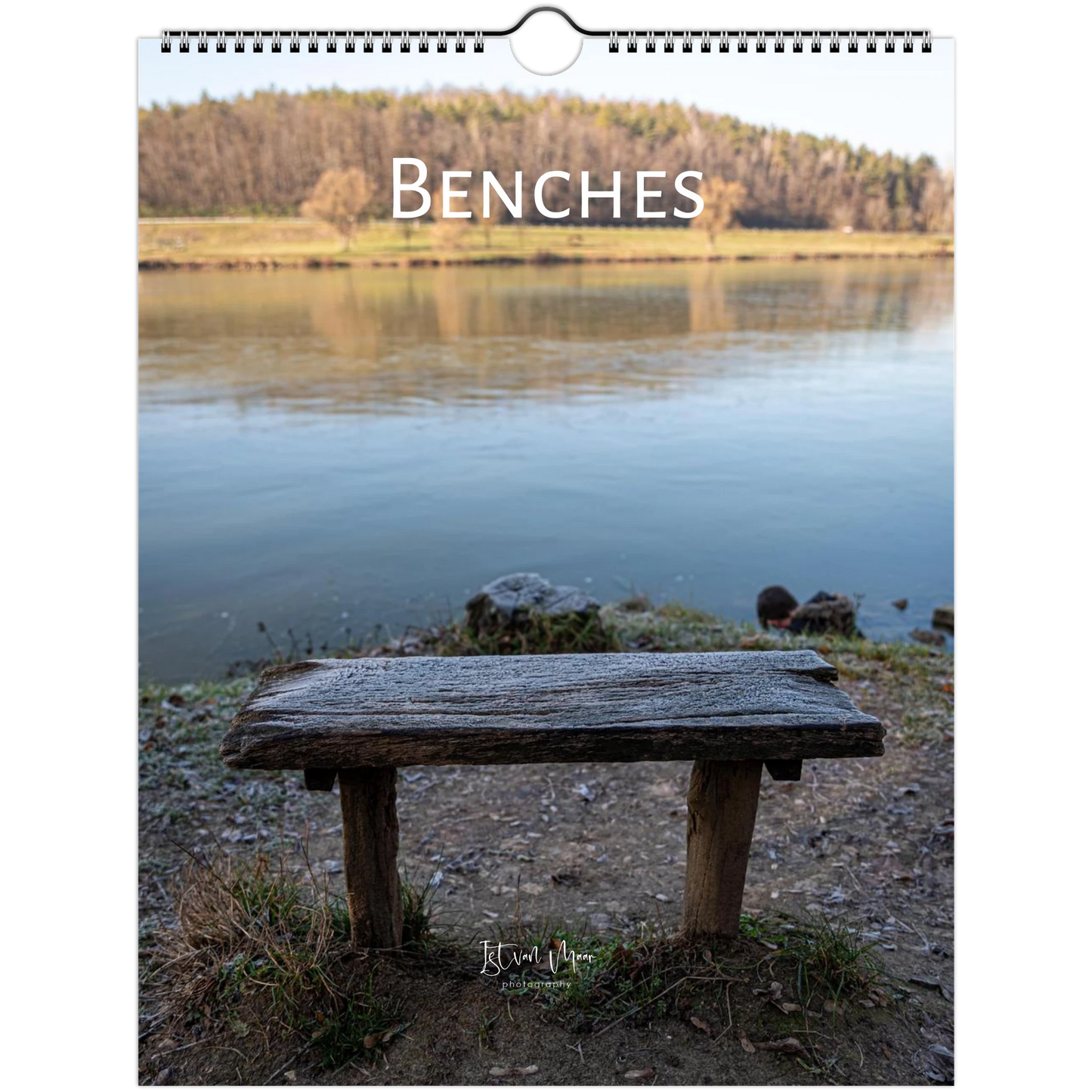 A spiral-bound wall calendar or print featuring a rustic wooden bench in the foreground of a calm lake scene, with the word 'BENCHES' printed across the top. Wall calendar is available in A4, A3, LT and Ledger US sizes. Ship worldwide.