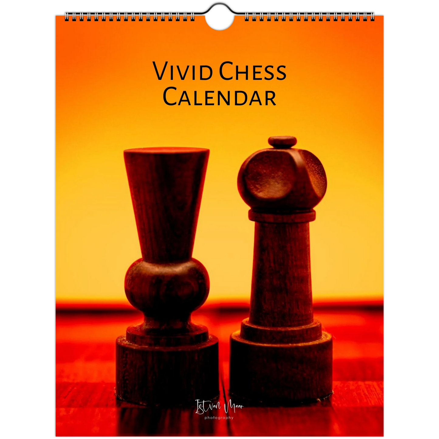 A hanging wall calendar titled 'VIVID CHESS CALENDAR' with a warm orange and yellow gradient cover showing two dark wooden chess pieces on a red tabletop. The spiral binding is visible at the top, and the product is photographed against a white background.