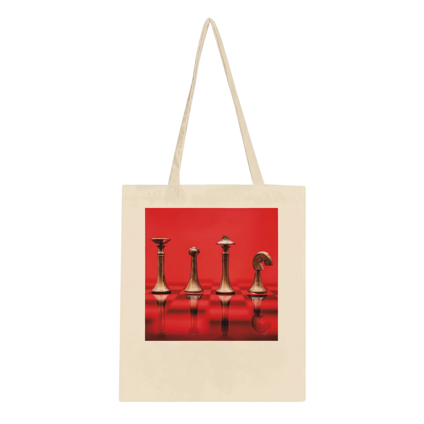 A natural canvas tote bag with long shoulder straps, featuring a square graphic print on the front of four metallic chess pieces against a vivid red background.