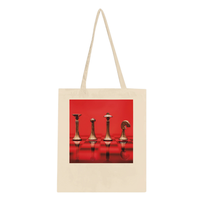 A natural canvas tote bag with long shoulder straps, featuring a square graphic print on the front of four metallic chess pieces against a vivid red background.