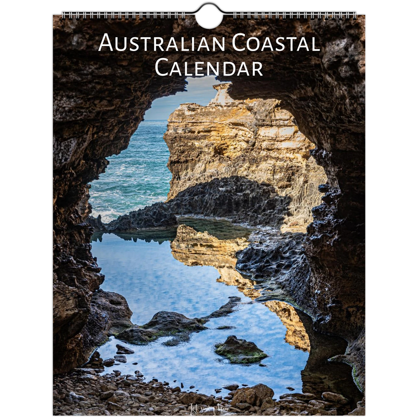 Australian Coastal Calendar wall hanging featuring a scenic photograph of a rocky coastal cave opening onto blue ocean water and a sunlit cliff, with the title 'AUSTRALIAN COASTAL CALENDAR' at the top.