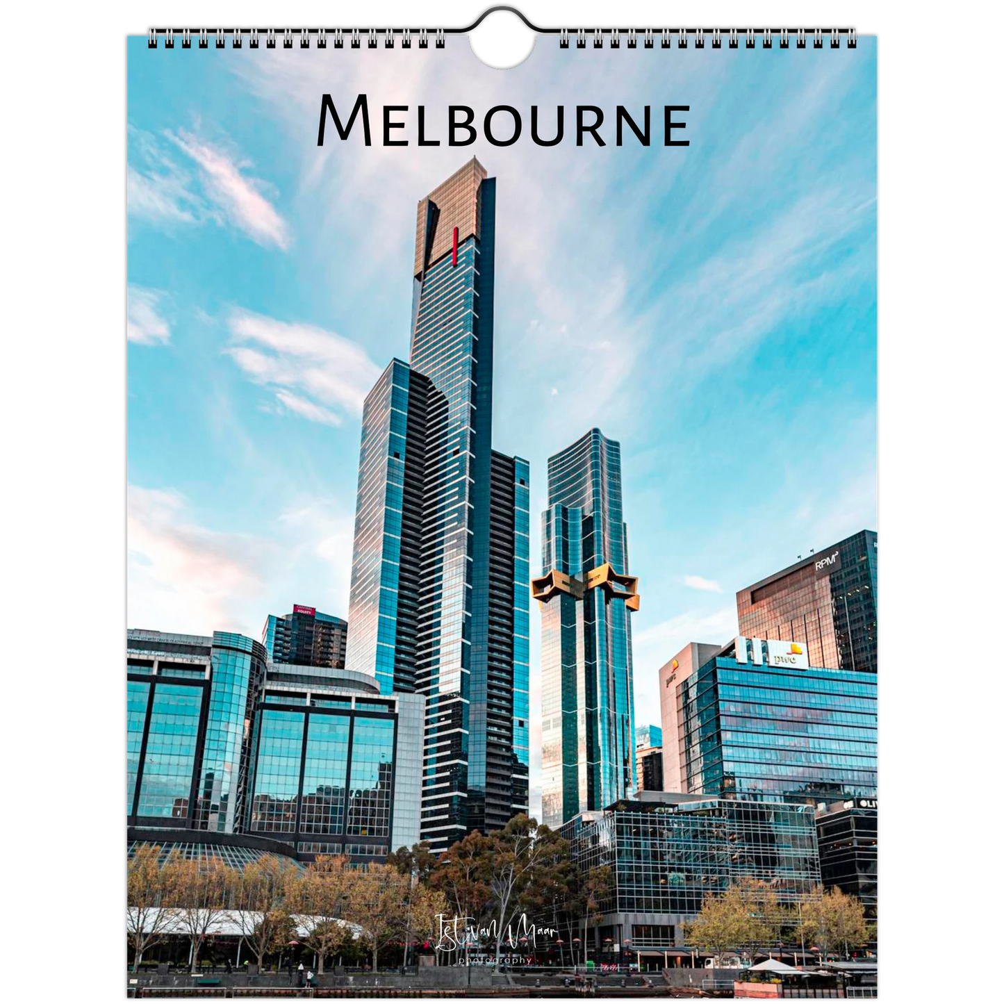 A hanging wall calendar page featuring a photograph of Melbourne's skyline, with the word 'MELBOURNE' printed at the top and a spiral binding hole near the top edge.