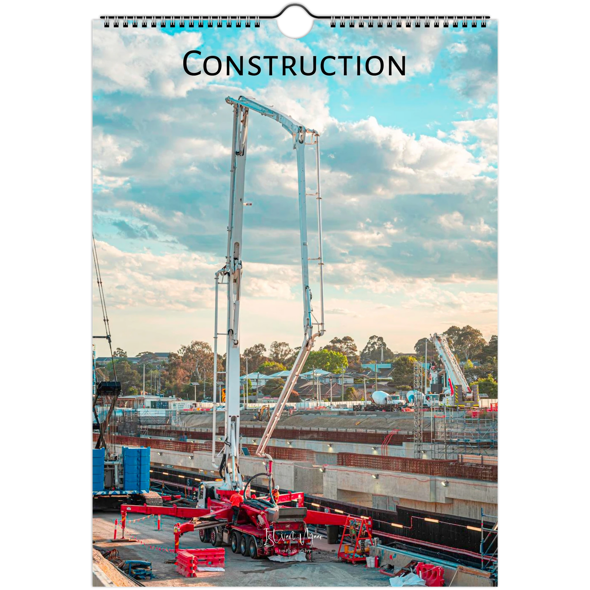 A spiral-bound wall calendar or print featuring a construction site scene with a tall concrete pump truck under a blue sky with clouds. The word "CONSTRUCTION" is printed at the top.