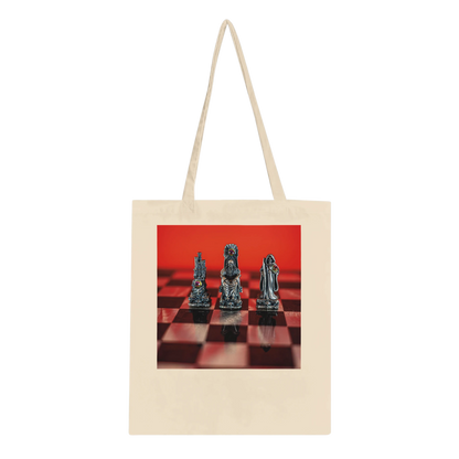 A natural canvas tote bag with long handles, featuring a rectangular printed graphic on the front of three metallic chess pieces on a red and black checkered board against a solid red background.