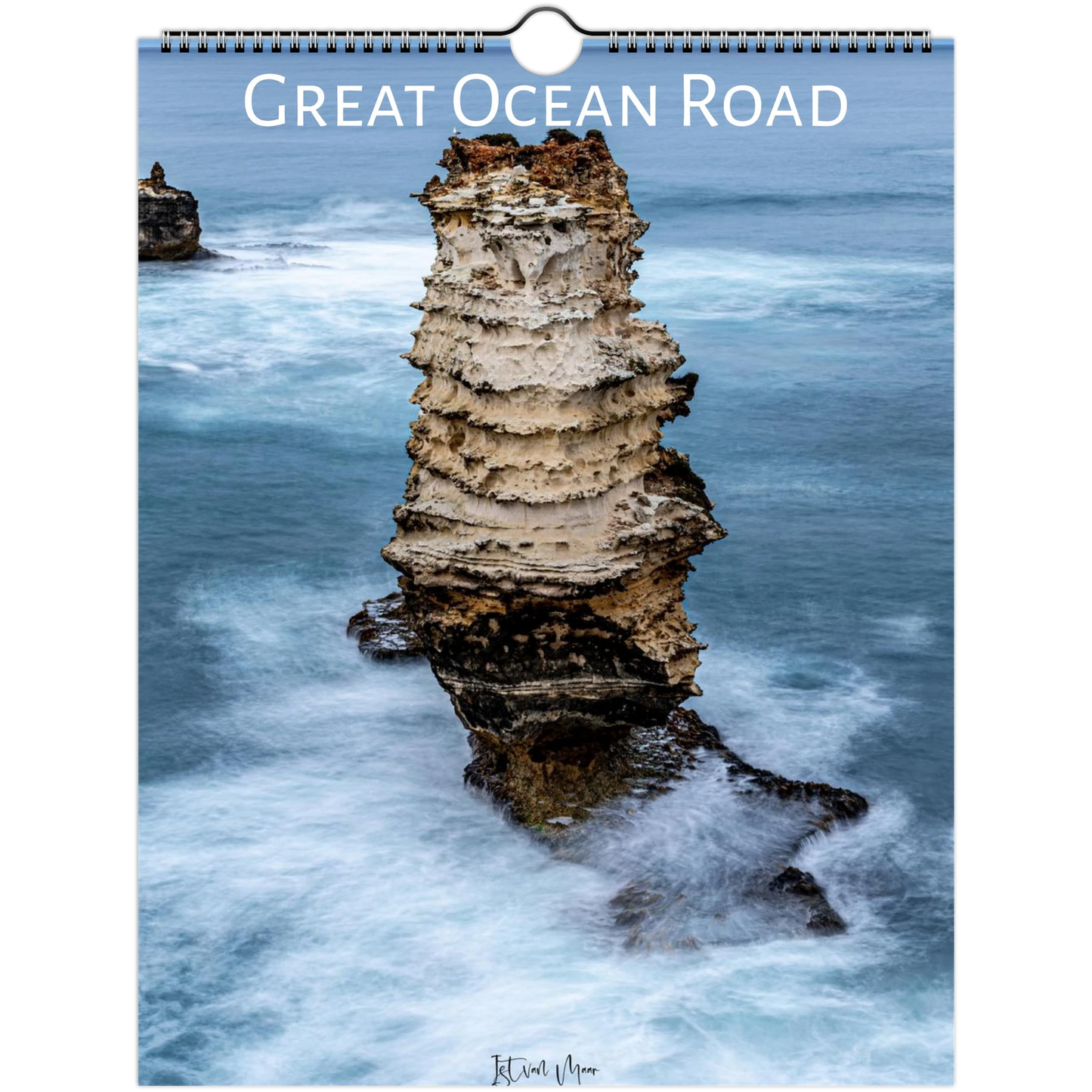 A spiral-bound wall calendar featuring a coastal photograph of a tall sea stack surrounded by blue ocean water and white surf, with the title 'Great Ocean Road' across the top.