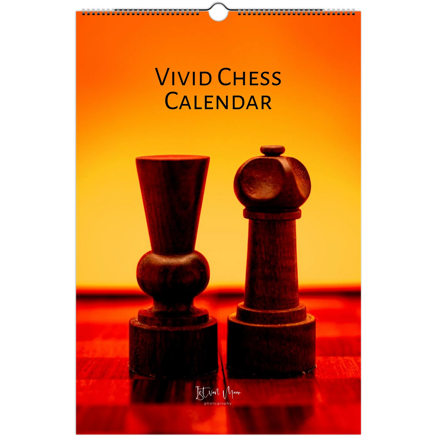 A wall calendar cover titled 'VIVID CHESS CALENDAR' featuring two dark wooden chess pieces on a red-orange gradient background. The calendar has a hanging hole at the top and visible spiral binding along the left edge.