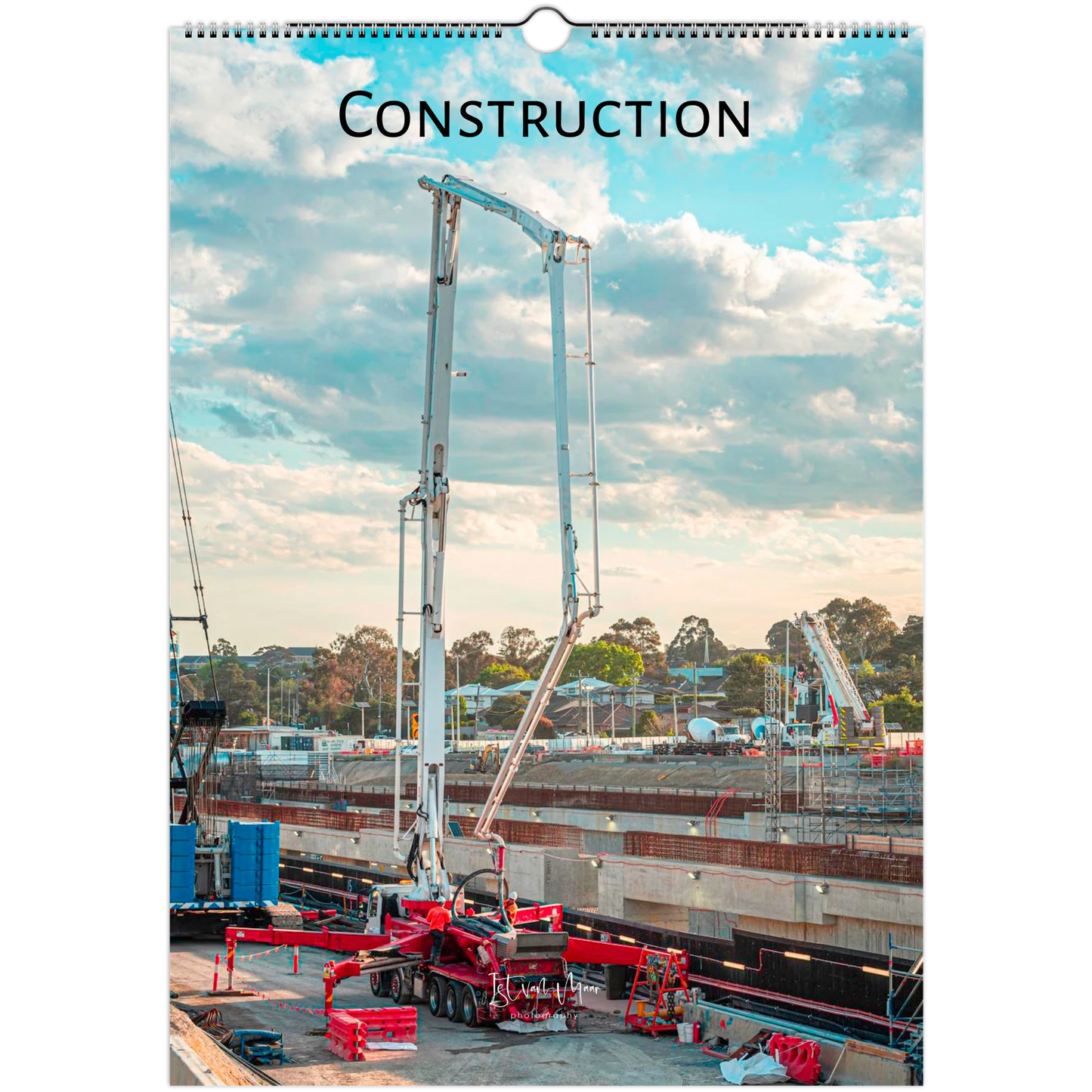 Construction calendar cover with crane and building site against a blue sky.