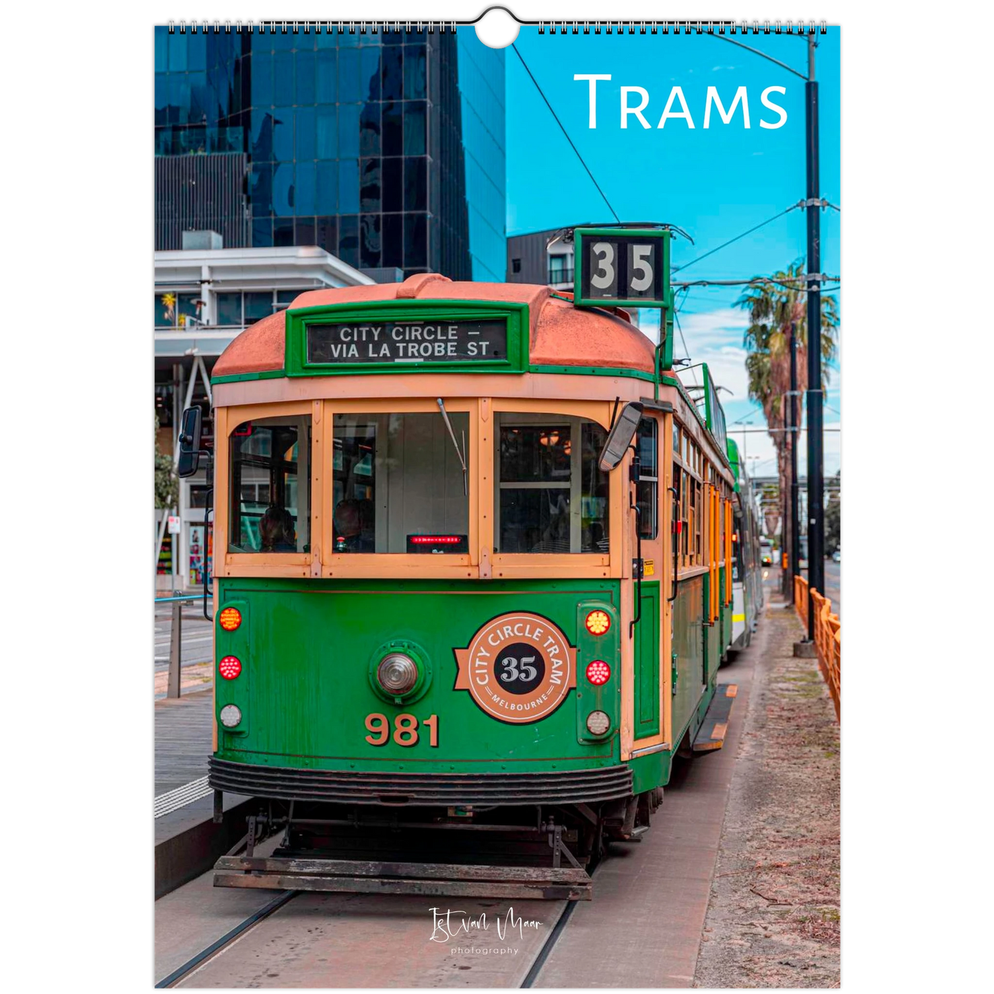 A hanging wall calendar page featuring a vintage green and cream tram on a city street, with the word 'TRAMS' printed at the top and a small circular 'Klippan' mark near the bottom.
