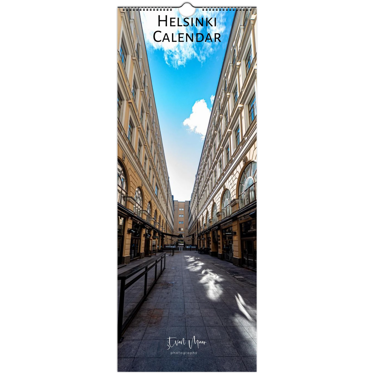 Helsinki calendar with a narrow street between buildings and blue sky.