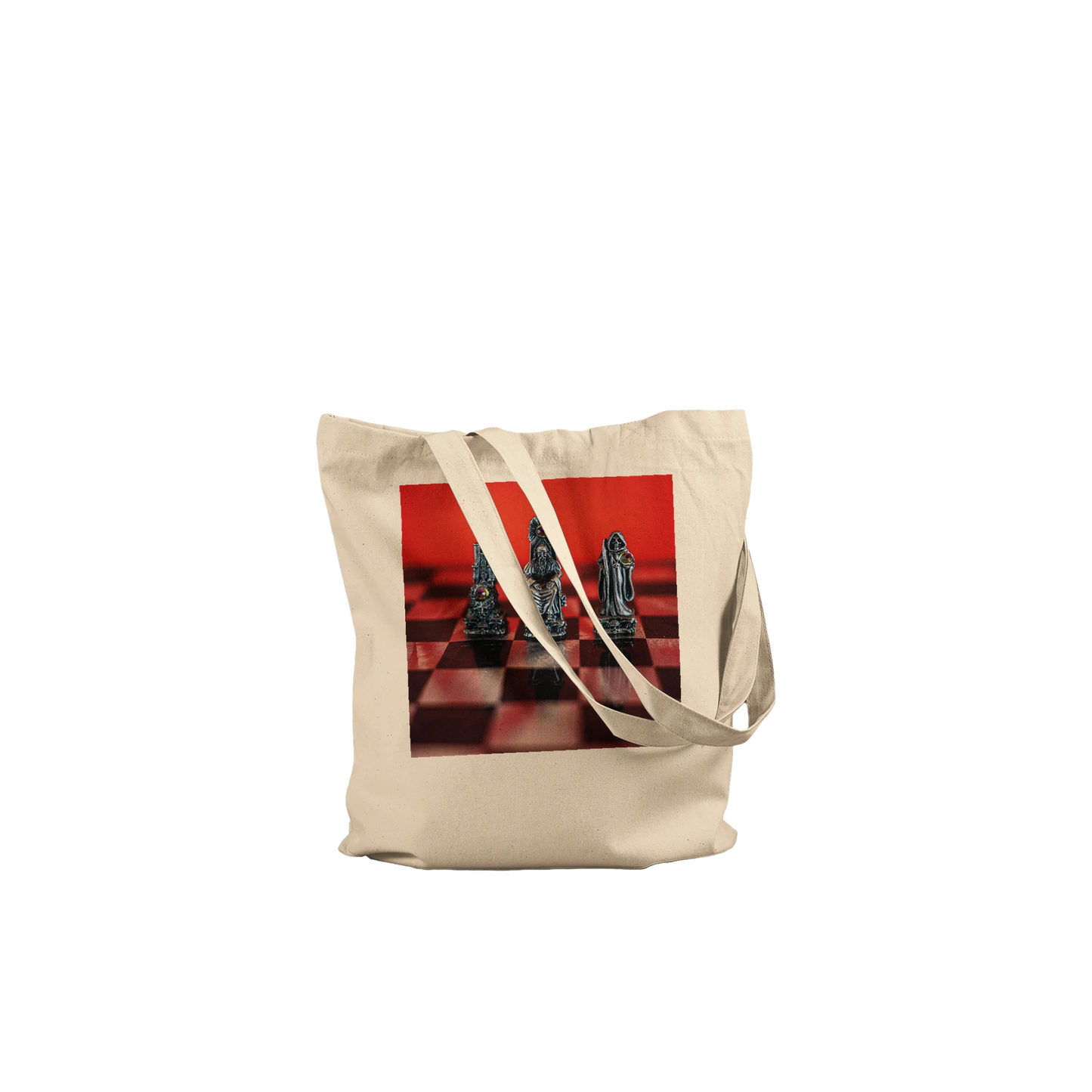 A natural canvas tote bag with a square graphic print of chess pieces on a red and black checkered board, set against a plain white background.
