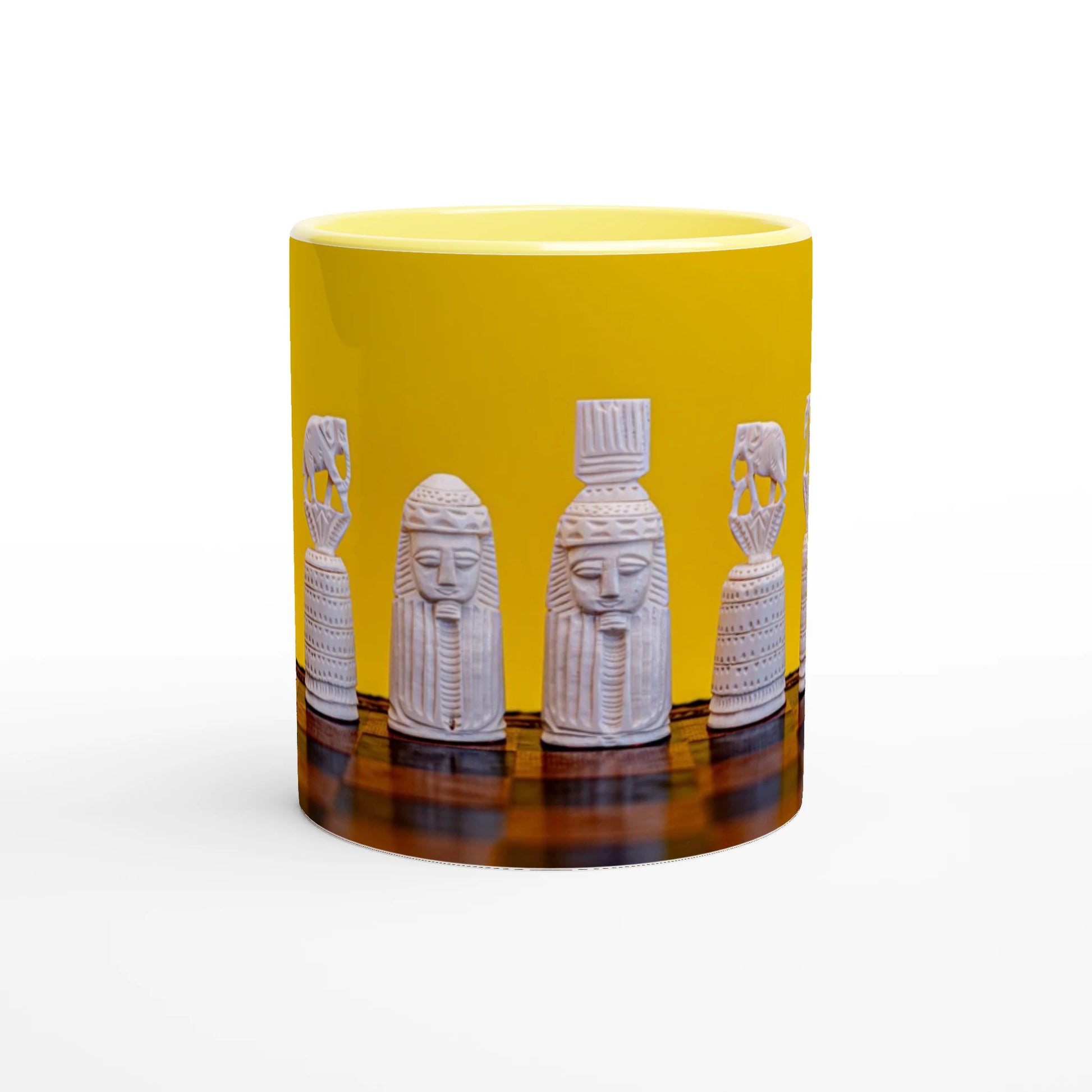 A yellow ceramic mug featuring a wrap-around graphic of white carved pharaoh-style statues on a dark reflective surface, shown against a plain white background.