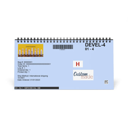 A spiral-bound desk calendar or notepad with a light blue cover, shown on a plain white background. The cover features black text, a barcode, a chess-themed graphic, and sample logo placeholders.