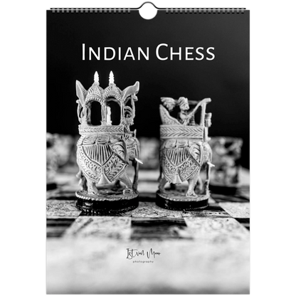 A spiral-bound wall calendar or print featuring a black-and-white photograph of ornate Indian chess pieces on a dark background, with the title 'INDIAN CHESS' at the top and a small photographer signature near the bottom.