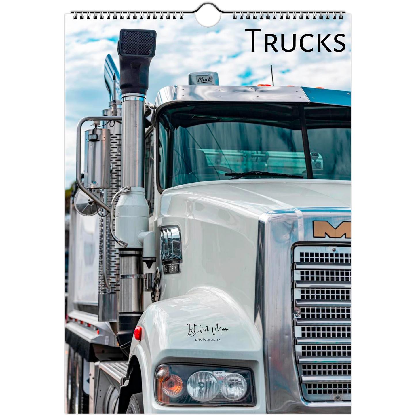 A spiral-bound wall calendar page featuring a close-up photograph of a white semi-truck with the word 'TRUCKS' printed at the top right.