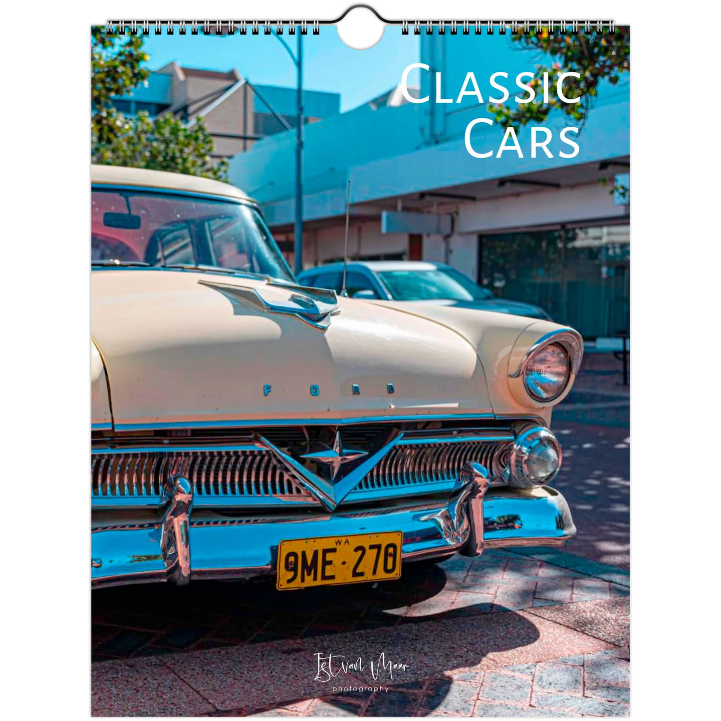 A spiral-bound wall calendar featuring a vintage cream-colored Ford car on a street, with the text 'CLASSIC CARS' at the top and a small 'Istvan Maar Photography' logo at the bottom.