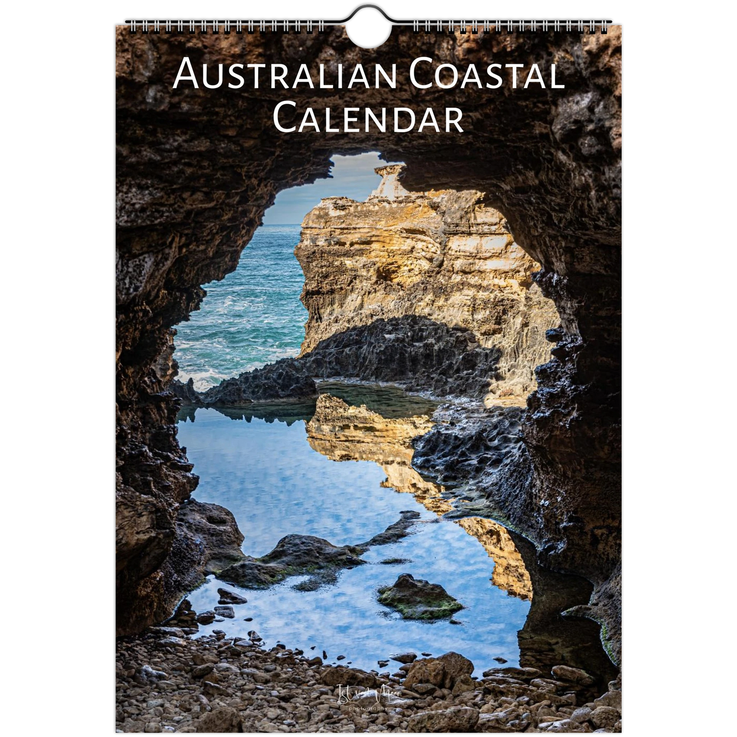 Australian Coastal Calendar featuring a scenic photograph of a rocky coastal cave opening onto blue water and sunlit cliffs, with the title 'AUSTRALIAN COASTAL CALENDAR' printed at the top.