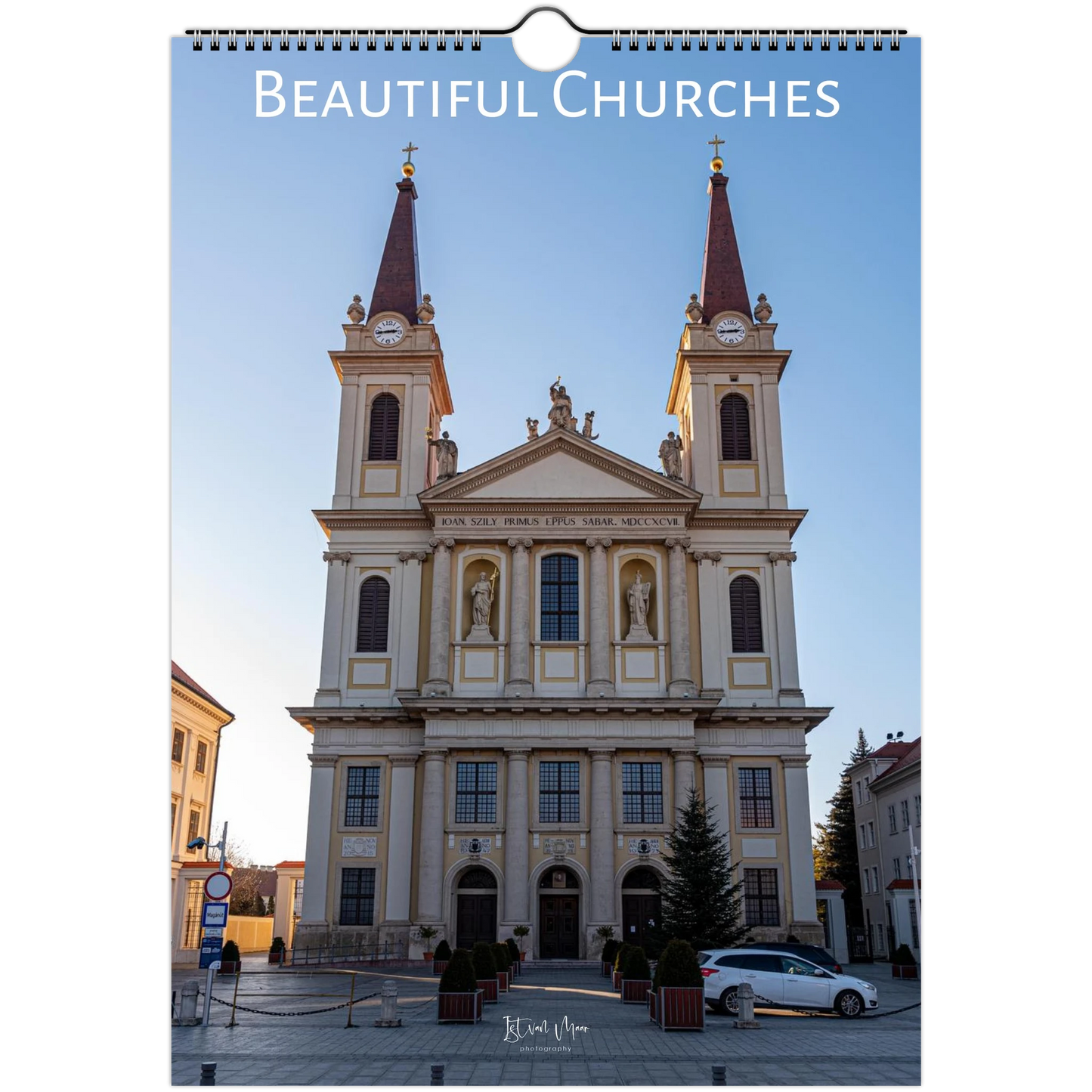 A spiral-bound wall calendar or photo print titled "Beautiful Churches" showing a large historic church facade with two towers, photographed against a white background.