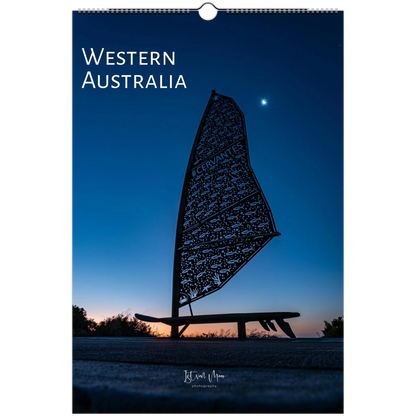 A vertical wall calendar or print featuring a scenic photograph of Western Australia at dusk or dawn, with a dark silhouette of a decorative sail-like sculpture against a deep blue sky. The words 'WESTERN AUSTRALIA' appear at the top, and a small photographer signature is visible near the bottom.