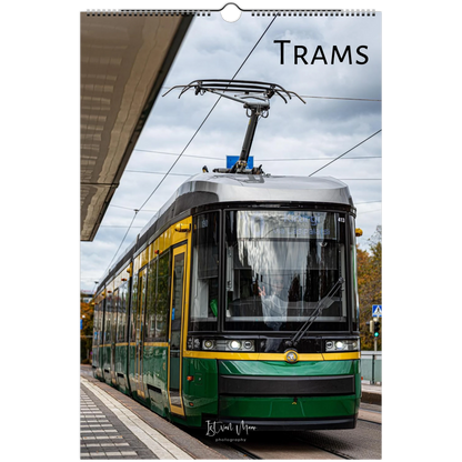 A spiral-bound wall calendar page featuring a photograph of a green and yellow tram on a city street under an overcast sky, with the word 'TRAMS' printed at the top. Original photography by Istvan Maar.