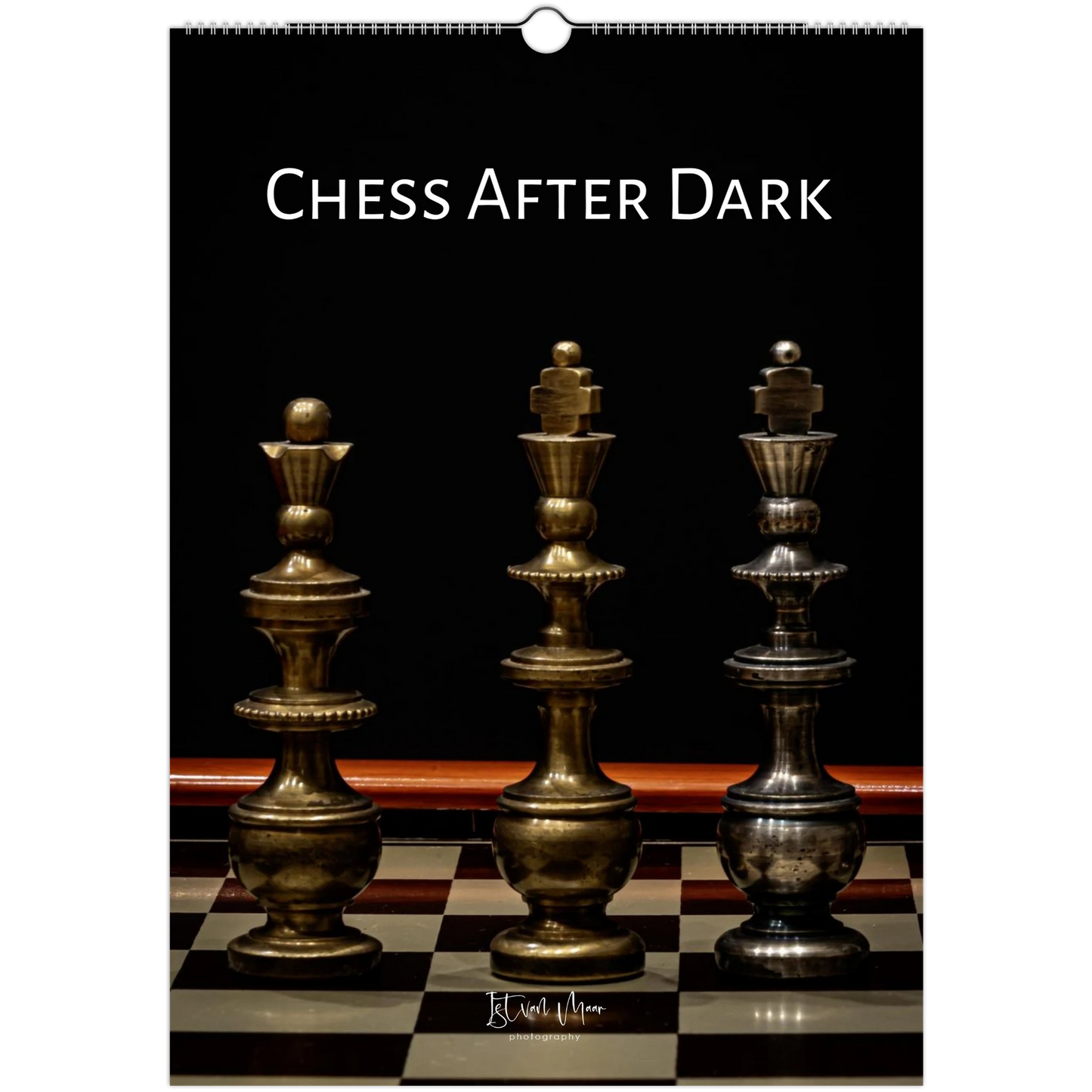 A wall calendar page titled 'CHESS AFTER DARK' showing three metallic chess pieces on a checkered board against a black background.