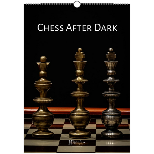 A wall calendar page titled 'CHESS AFTER DARK' showing three metallic chess pieces on a checkered board against a black background.