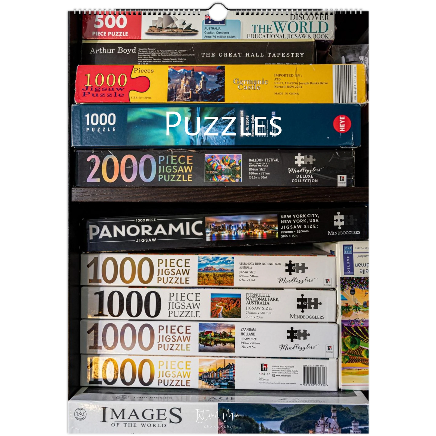 Collection of various puzzle boxes with titles and images on a white background