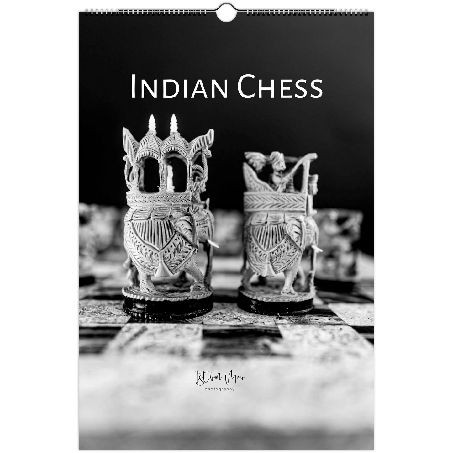 A black and white wall calendar page featuring a photograph of ornate Indian chess pieces on a board, with the title 'INDIAN CHESS' at the top and a small 'Istvan Maar photography' signature near the bottom.