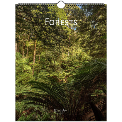 A spiral-bound wall calendar or print featuring a forest scene with ferns and trees, with the word 'FORESTS' printed across the top and a small artist signature near the bottom.