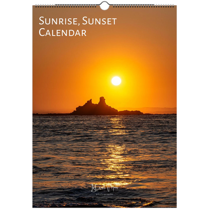 A wall calendar titled 'SUNRISE, SUNSET CALENDAR' featuring a sunset over the sea with a rocky island silhouette. The cover has a hanging loop at the top and a small script logo near the bottom.
