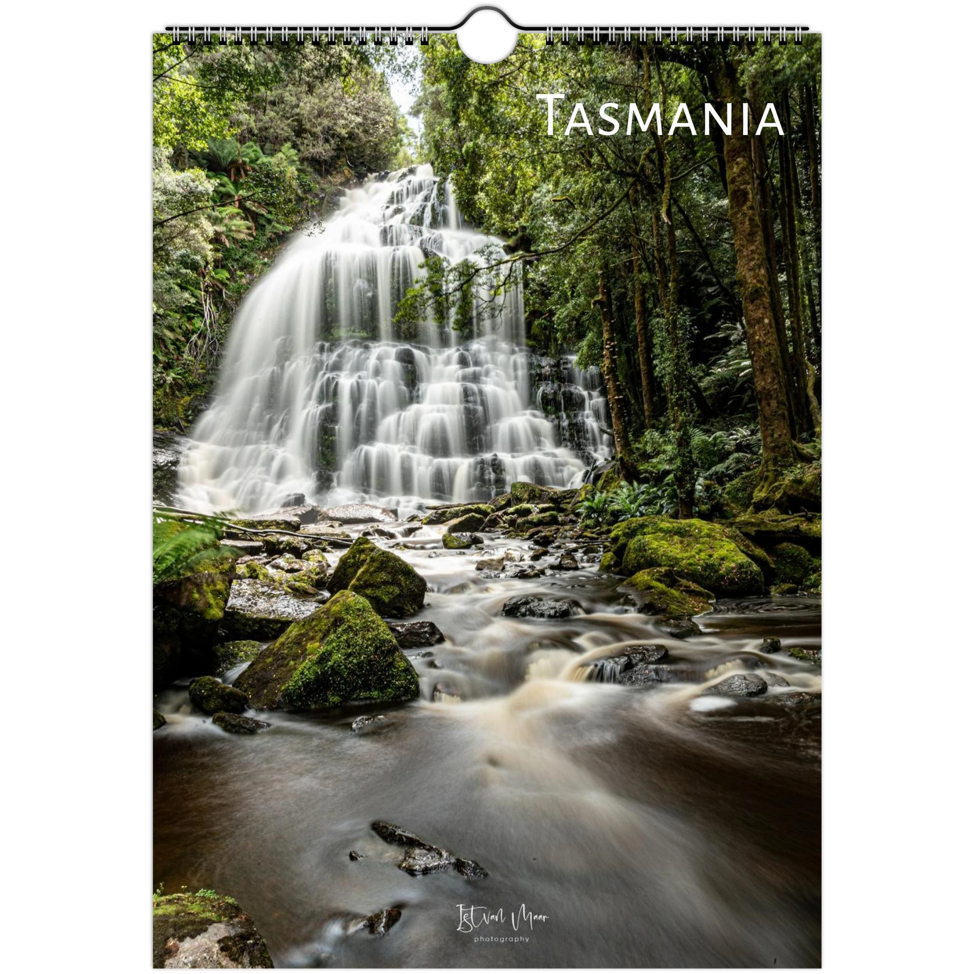 A vertical wall calendar featuring a long-exposure photograph of a waterfall in a lush green forest, with the word TASMANIA printed at the top and a hanging hole near the top center.