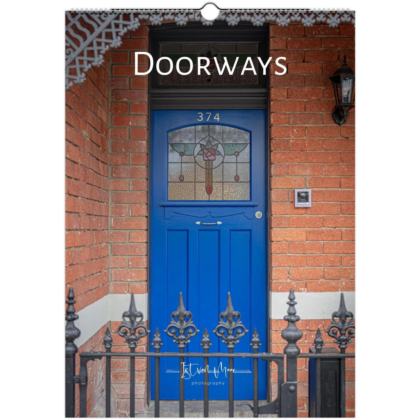 Calendar cover with a blue door on a brick wall, featuring the title 'Doorways' and photographer's name.
