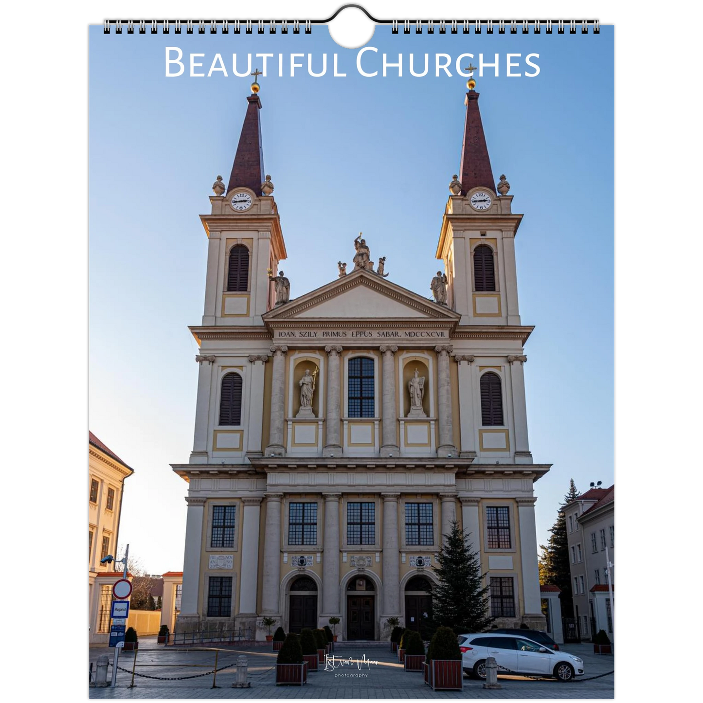 A spiral-bound wall calendar or poster showing a large neoclassical church facade under a clear blue sky, with the title 'Beautiful Churches' printed across the top. Calendar available in A4, A3, LT and Ledger US sizes