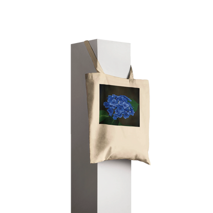 Natural canvas tote bag printed with a blue hydrangea photograph, Classic style, hanging profile view